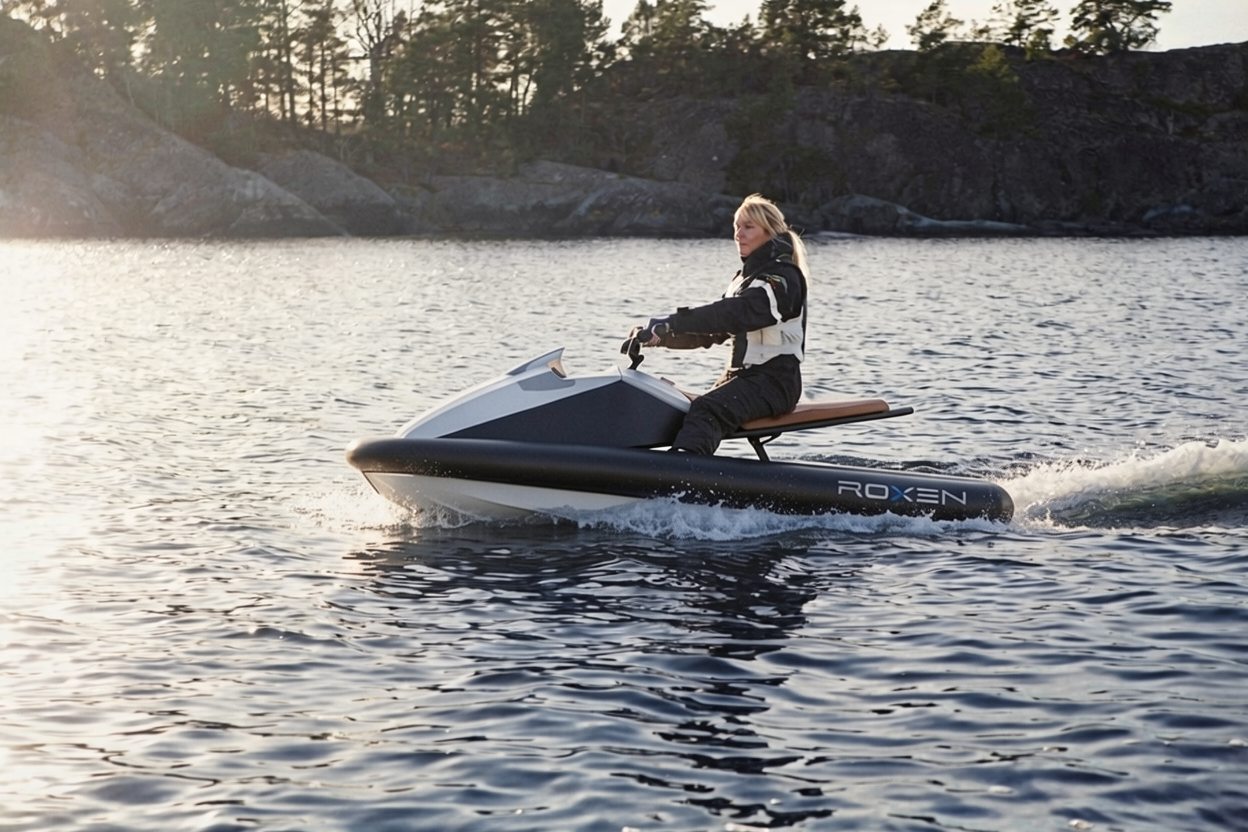 Person riding a water scooter on a body of water with a scenic background